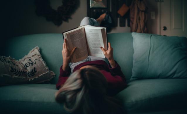 Girl relaxing and reading a book
